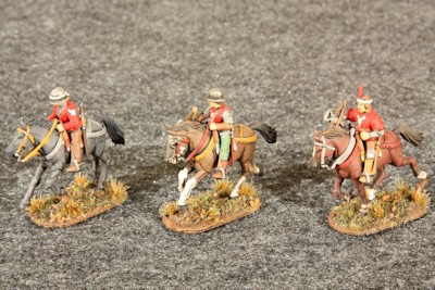 Three mounted light horse galloping left