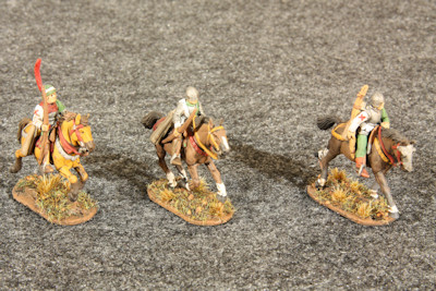 Three mounted light horse galloping right