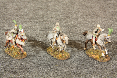 Three mounted heavy horse galloping right