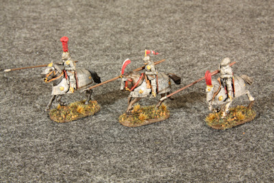 Three mounted heavy horse galloping left